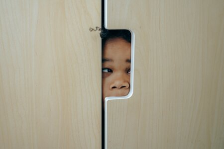 Sneak Peek Boy looking through peek hole